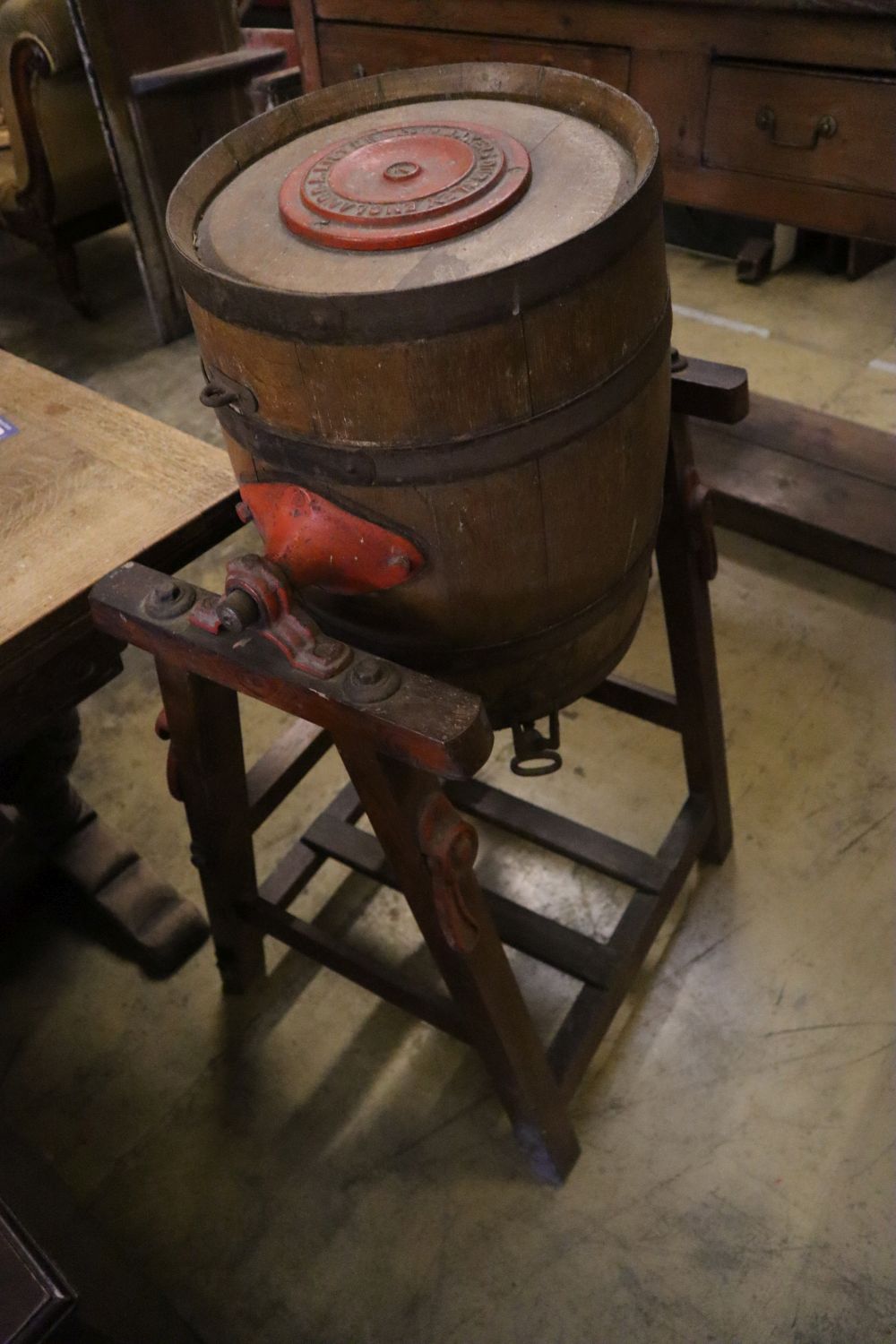 An early 20th century butter churn and two butter pats, width 64cm height 103cm